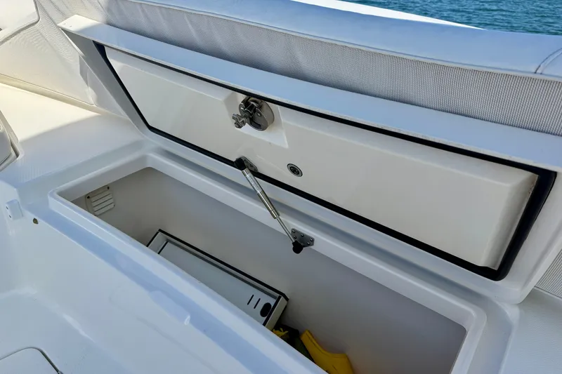 Slide: The Image of Open storage compartment on a 2014 Regulator 28 Forward Seating boat. - 22