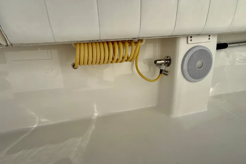 Slide: The Image of 2014 Regulator 28 Forward Seating boat interior with coiled hose and speaker. - 37