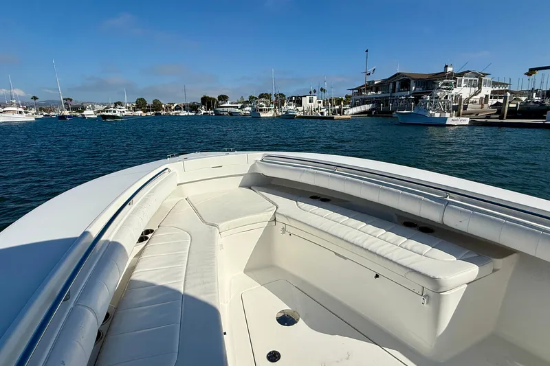 Slide: The Image of 2014 Regulator 28 Forward Seating boat in a marina, showcasing spacious seating and calm waters. - 30