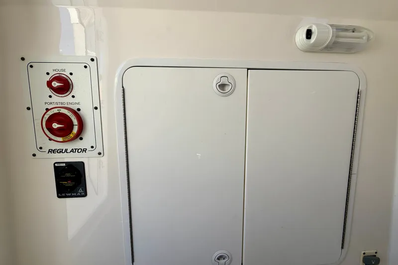 Slide: The Image of Control panel and storage compartment on a 2014 Regulator 28 Forward Seating boat. - 19