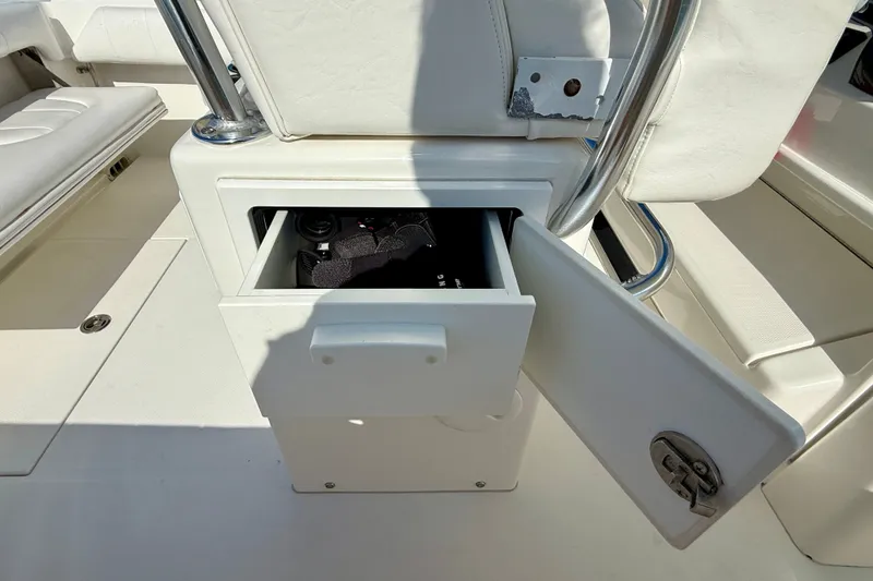 Slide: The Image of Open storage compartment on a 2014 Regulator 28 Forward Seating boat. - 35