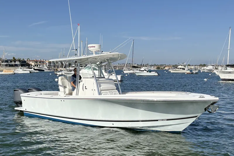 The Image of 2014 Regulator 28 Forward Seating boat on water, surrounded by other vessels. - 0
