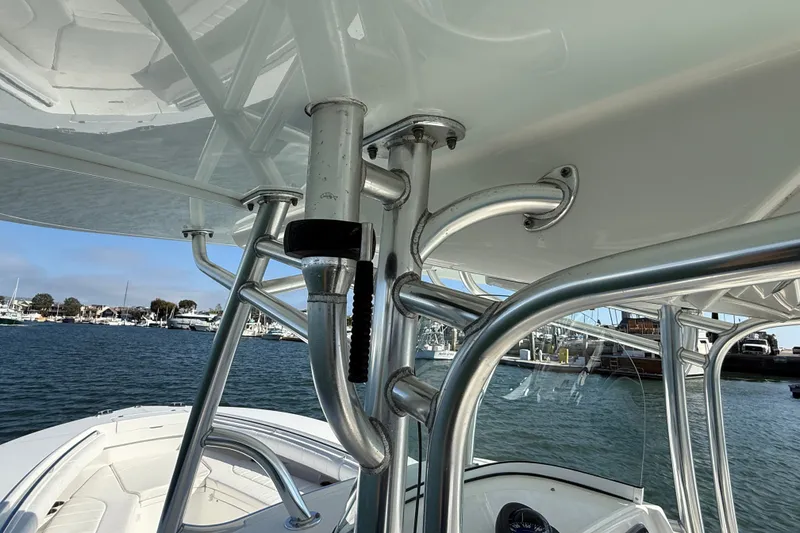 Slide: The Image of 2014 Regulator 28 Forward Seating boat with stainless steel T-top frame on the water. - 34