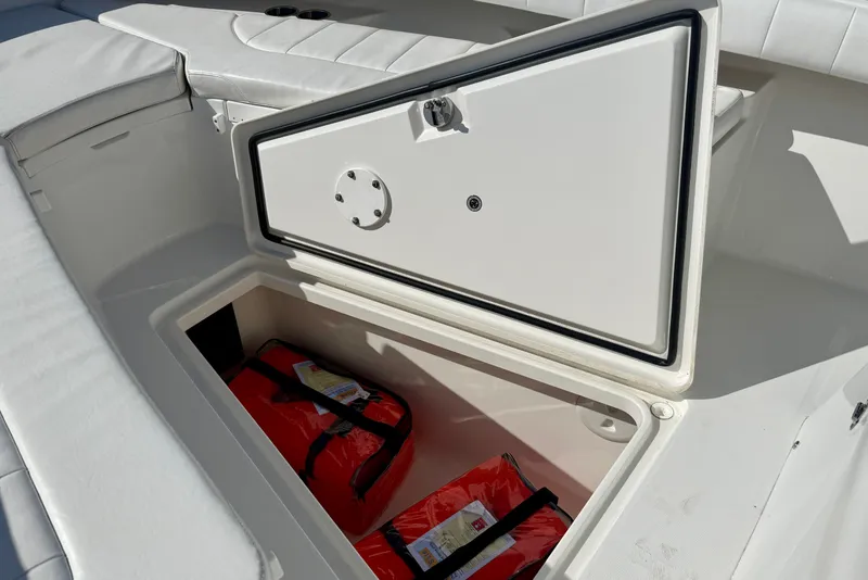 Slide: The Image of Storage compartment on a 2014 Regulator 28 Forward Seating boat with life jackets inside. - 20