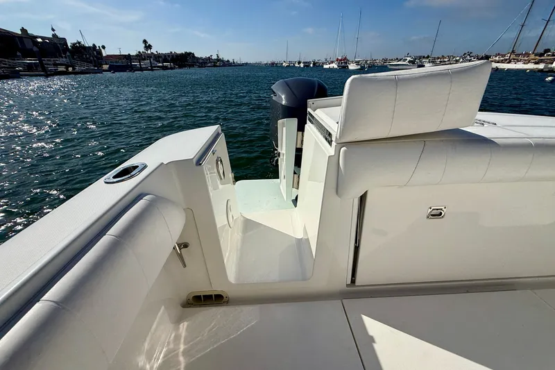 Slide: The Image of 2014 Regulator 28 Forward Seating boat on water, showcasing sleek design and comfortable seating. - 27