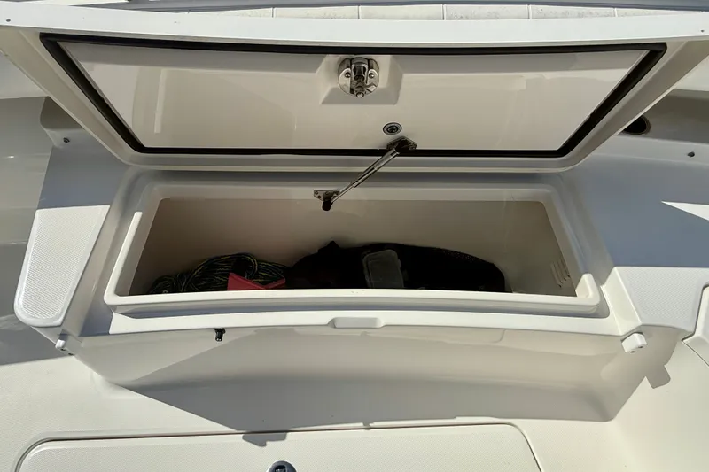 Slide: The Image of Open storage compartment on a 2014 Regulator 28 Forward Seating boat. - 23