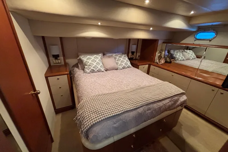 Slide: The Image of Luxurious 1996 Queenship yacht bedroom with elegant bedding and wooden cabinetry. - 5