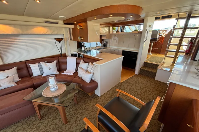 Slide: The Image of Luxurious 1996 Queenship yacht interior with cozy seating, modern kitchen, and elegant decor. - 26