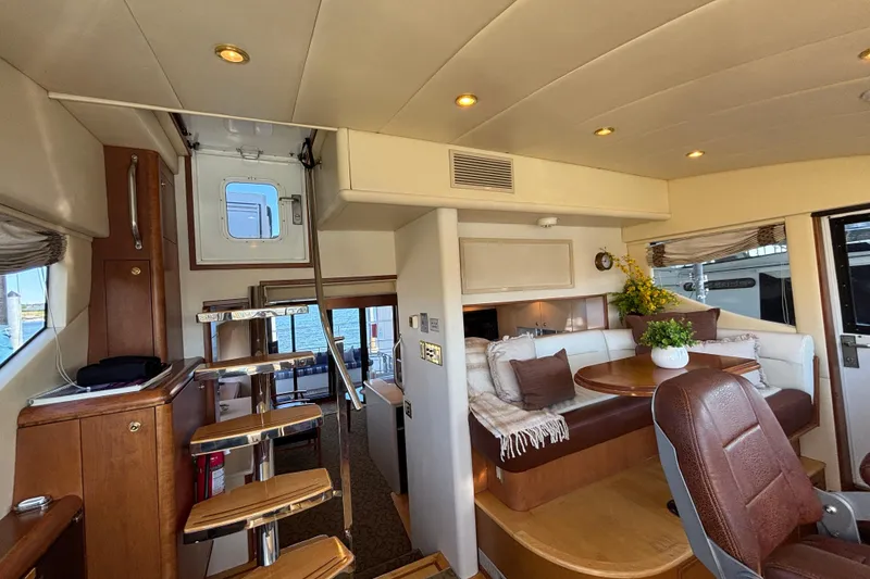 Slide: The Image of Luxurious 1996 Queenship yacht interior with elegant seating and wooden accents. - 21