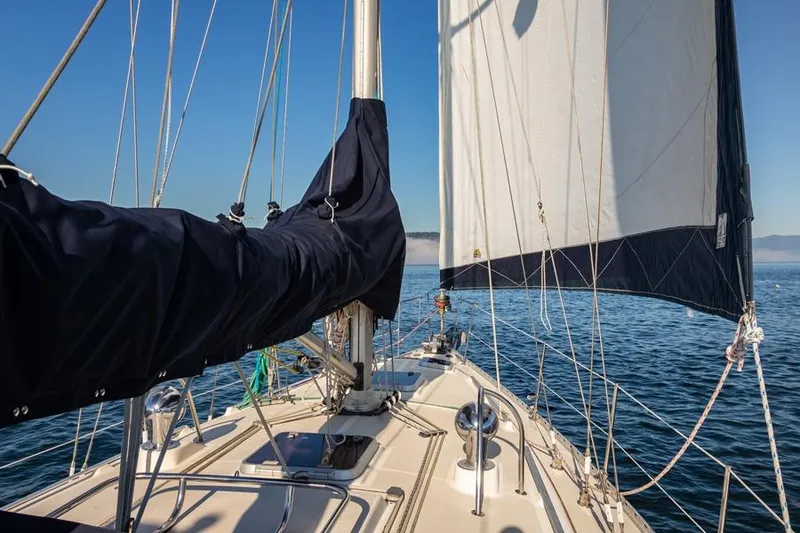 Slide: The Image of Sailing on a 2002 Caliber 40 yacht with clear blue skies and calm waters. - 13