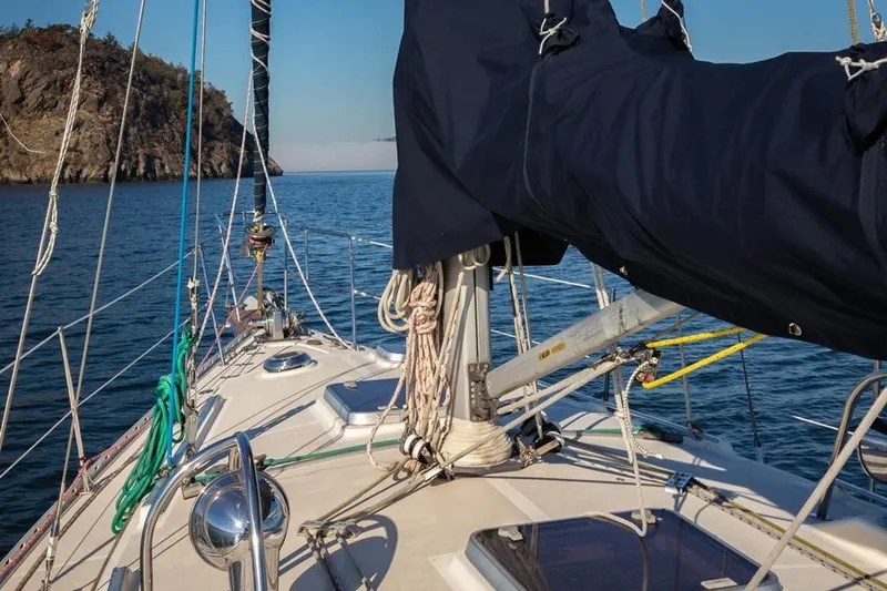 Slide: The Image of Sailing yacht Caliber 40, 2002 model, cruising near rocky coastline. - 12