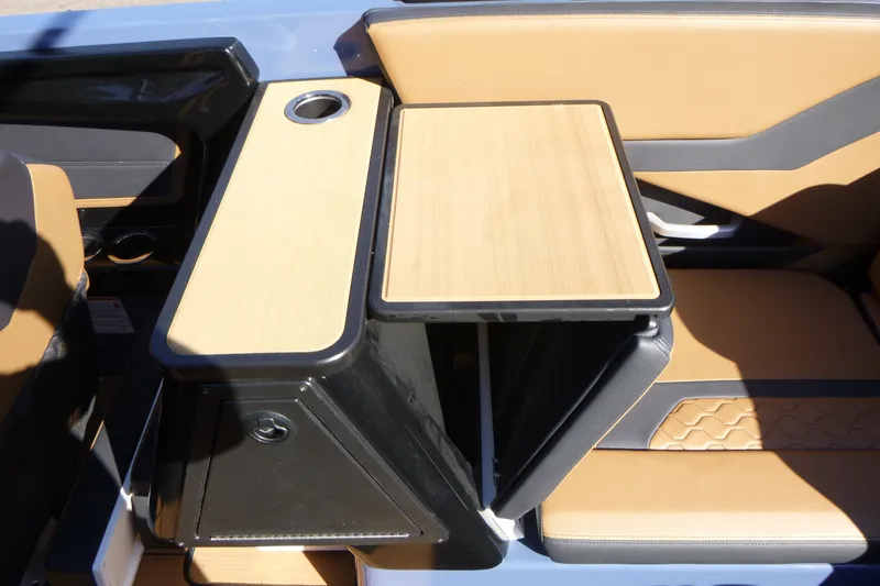 Slide: The Image of 2024 Yamaha Boats 255XD interior with tan seating and foldable table. - 14