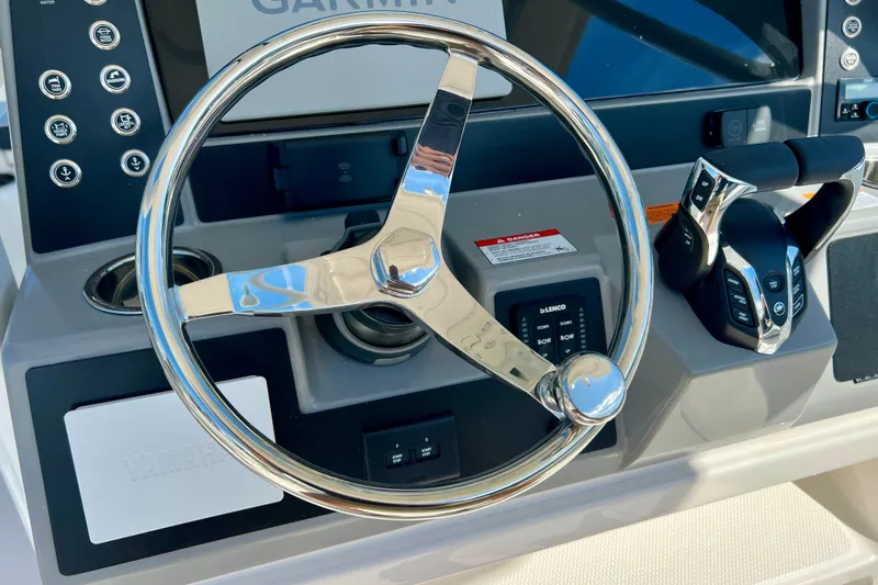 Slide: The Image of Steering wheel and controls of 2027 Robalo R250 Center Console boat. - 18