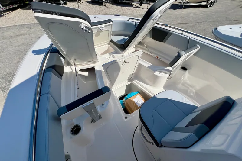 Slide: The Image of 2027 Robalo R250 Center Console boat interior with open storage compartments and seating. - 21