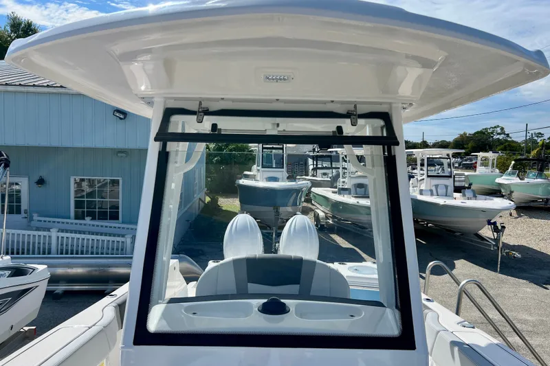 Slide: The Image of 2027 Robalo R250 Center Console boat displayed at a marina under clear skies. - 24