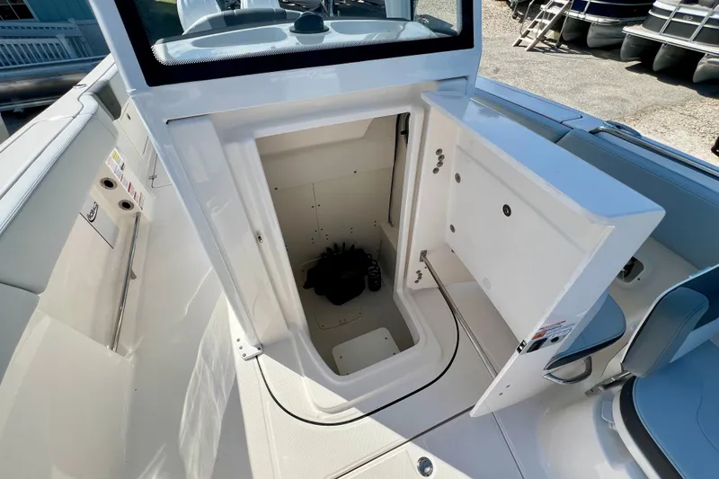 Slide: The Image of 2027 Robalo R250 Center Console boat with open storage compartment. - 22