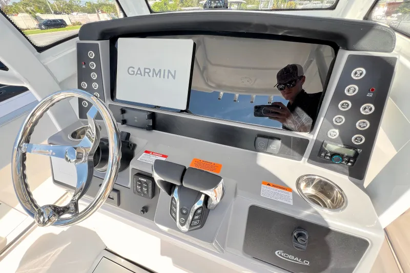 Slide: The Image of 2027 Robalo R250 Center Console dashboard with Garmin display and steering wheel. - 15