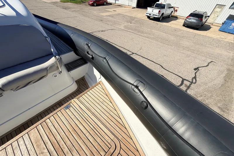Slide: The Image of 2011 Protector Tauranga 38 boat with wooden deck and inflatable side. - 21