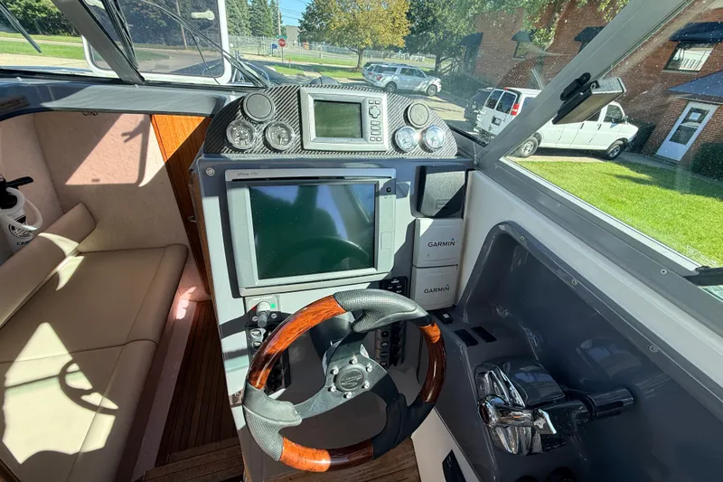 Slide: The Image of Interior cockpit of 2011 Protector Tauranga 38 boat with steering wheel and navigation equipment. - 26