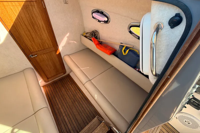 Slide: The Image of Interior of 2011 Protector Tauranga 38 boat with beige seating and wooden accents. - 37