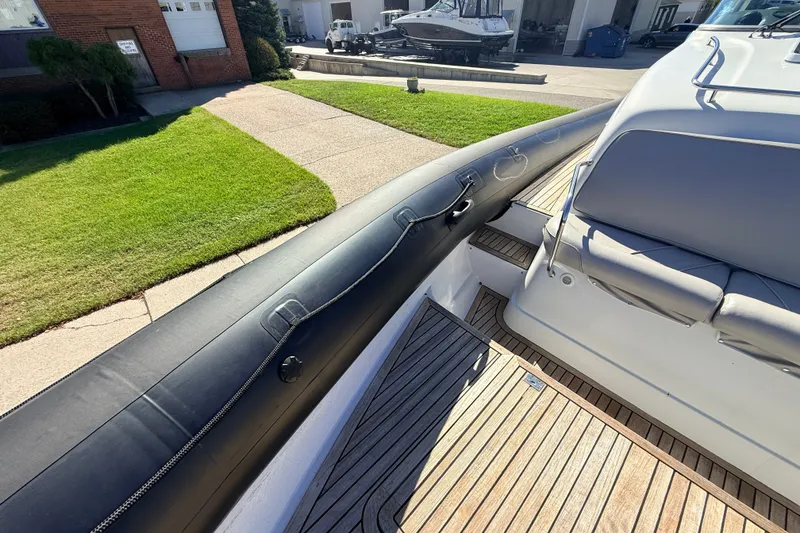 Slide: The Image of 2011 Protector Tauranga 38 boat with sleek deck and cushioned seating. - 15