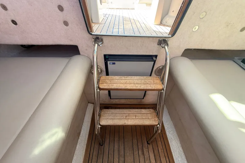 Slide: The Image of Interior view of 2011 Protector Tauranga 38 boat with wooden steps and seating. - 41