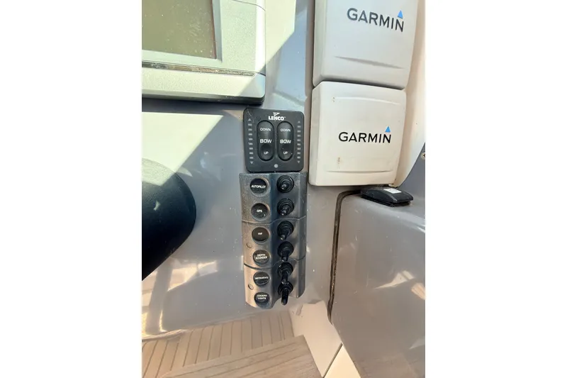Slide: The Image of Control panel of a 2011 Protector Tauranga 38 boat with Garmin devices. - 30