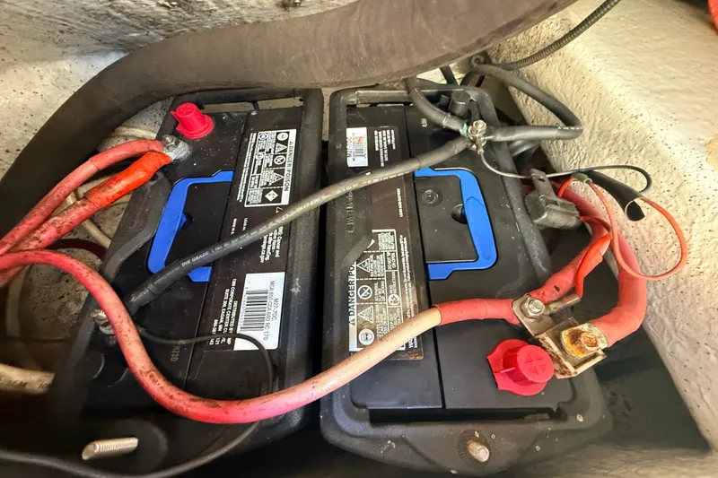 Slide: The Image of Battery compartment of a 2011 Protector Tauranga 38 boat with connected cables. - 51