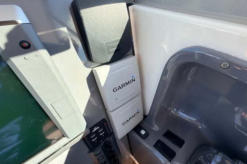 Slide: The Image of Garmin equipment on 2011 Protector Tauranga 38 boat dashboard, featuring navigation controls. - 28