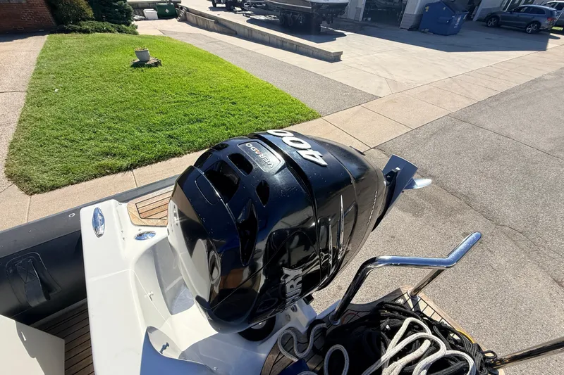 Slide: The Image of Outboard motor on 2011 Protector Tauranga 38 boat, parked on driveway. - 49
