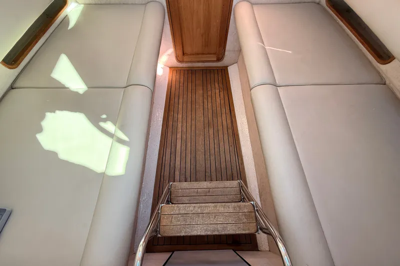 Slide: The Image of Interior of 2011 Protector Tauranga 38 boat with wooden flooring and cushioned seating. - 40