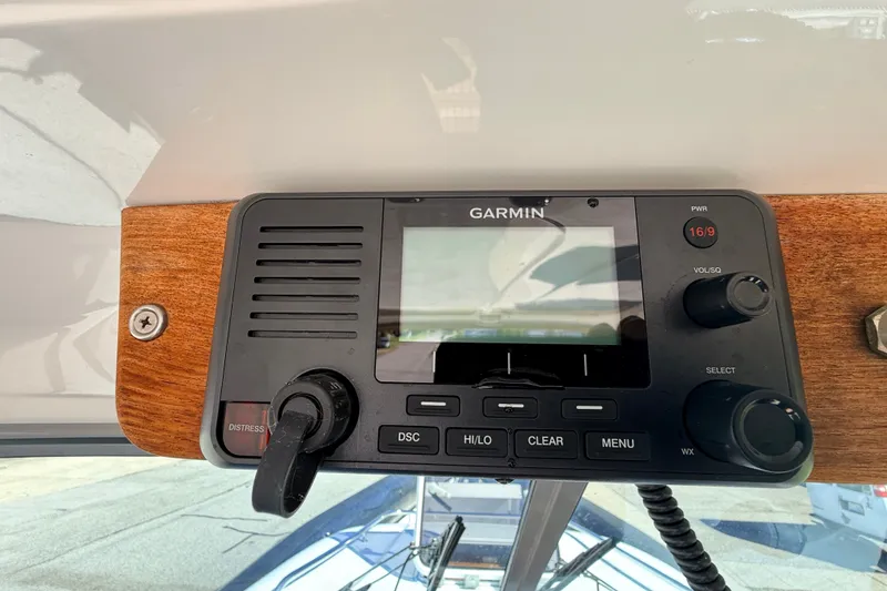 Slide: The Image of Garmin marine radio on 2011 Protector Tauranga 38 boat dashboard. - 32