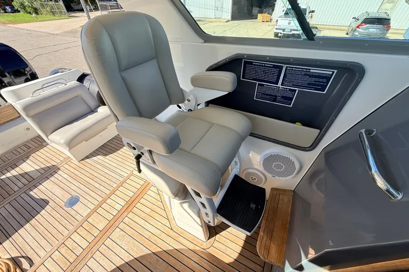 Slide: The Image of Captain's chair on 2011 Protector Tauranga 38 boat with teak flooring. - 34