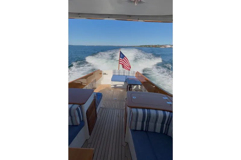 Slide: The Image of Hinckley Picnic Boat 37 MKIII cruising, American flag waving, teak deck, ocean view. - 15