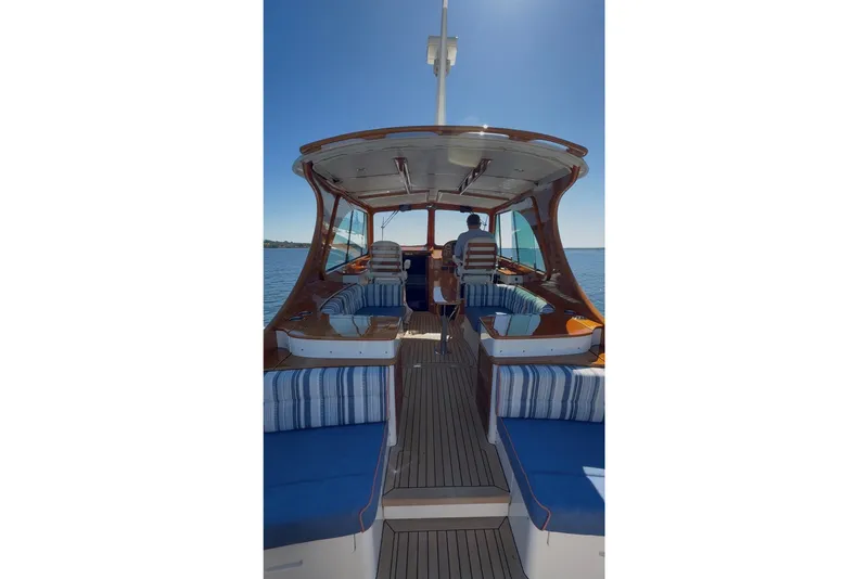 Slide: The Image of 2014 Hinckley Picnic Boat 37 MKIII with striped seating, cruising on open water. - 14
