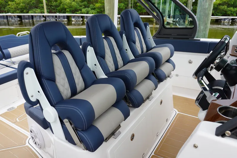 Slide: The Image of Luxurious seating on 2027 Monterey Elite 34 OB boat, featuring blue and gray upholstery. - 22
