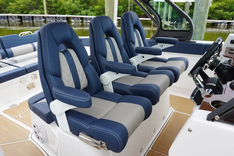 Slide: The Image of Luxurious seating on 2027 Monterey Elite 34 OB boat, featuring blue and gray upholstery. - 23