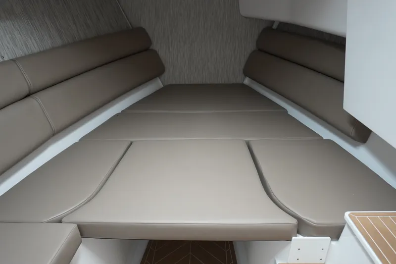 Slide: The Image of 2027 Monterey Elite 34 OB interior cabin with beige cushioned seating. - 32
