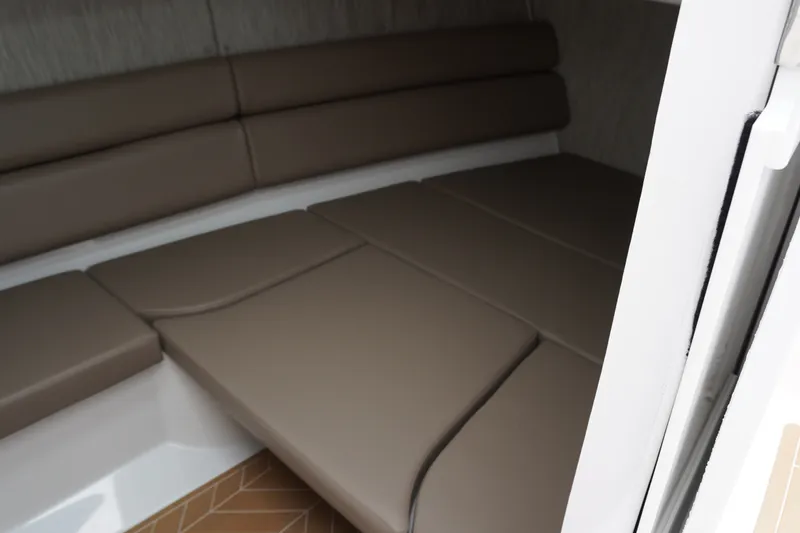 Slide: The Image of Interior cabin of 2027 Monterey Elite 34 OB with beige cushioned seating. - 30