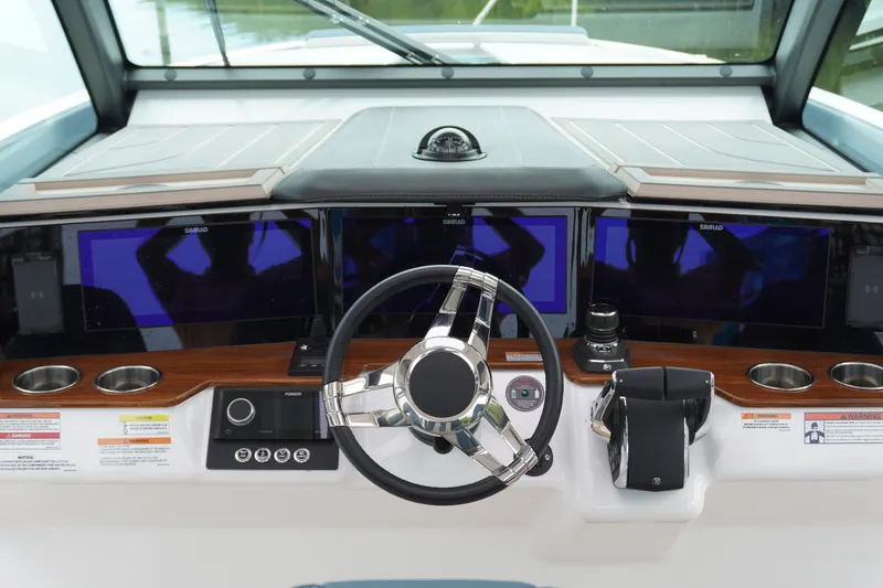 Slide: The Image of 2027 Monterey Elite 34 OB boat dashboard with modern controls and navigation screens. - 24