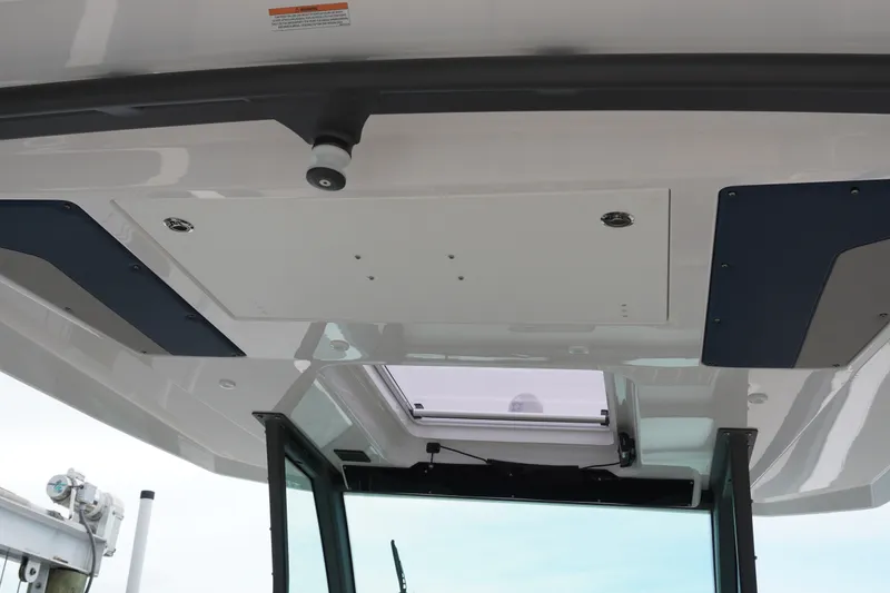 Slide: The Image of 2027 Monterey Elite 34 OB boat interior ceiling with skylight and modern design. - 20