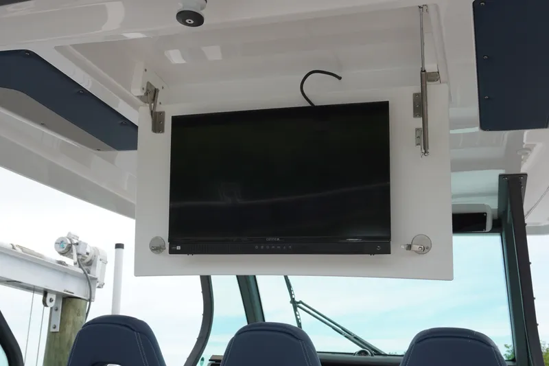 Slide: The Image of Flat-screen TV mounted on a 2027 Monterey Elite 34 OB boat ceiling. - 21