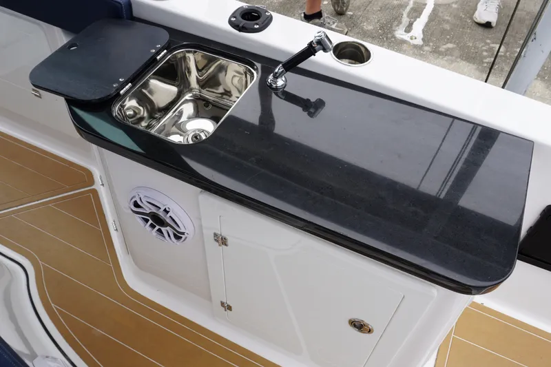 Slide: The Image of Luxury kitchenette on 2027 Monterey Elite 34 OB boat with sink and storage. - 19