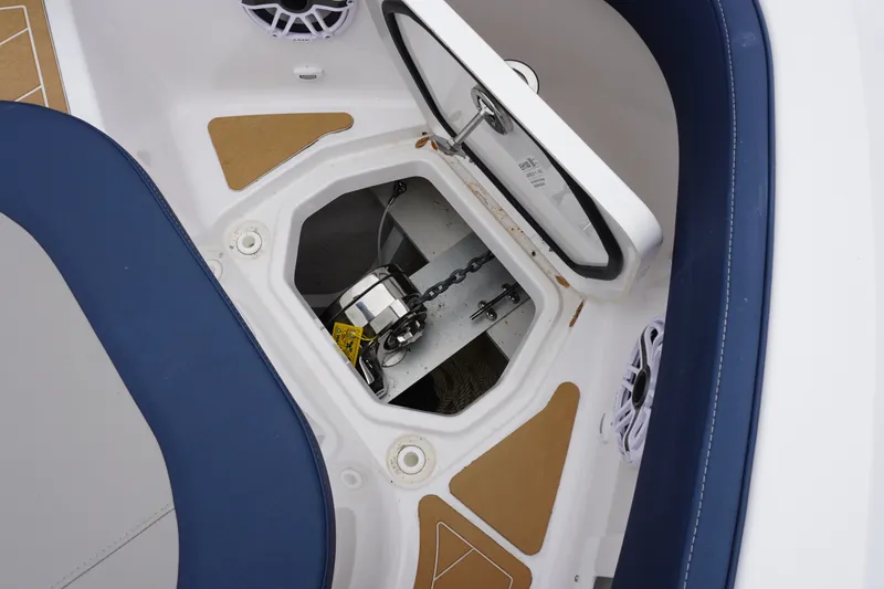 Slide: The Image of Anchor storage compartment on 2027 Monterey Elite 34 OB boat, featuring blue seating and speakers. - 35