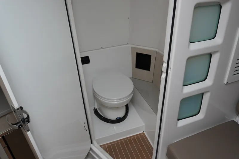 Slide: The Image of 2027 Monterey Elite 34 OB boat bathroom interior with modern design and compact toilet. - 33