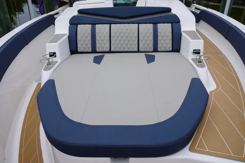 Slide: The Image of Luxurious seating area on 2027 Monterey Elite 34 OB boat, featuring blue and gray upholstery. - 28