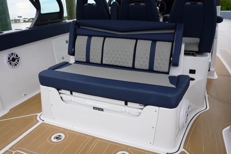 Slide: The Image of Luxury seating on 2027 Monterey Elite 34 OB boat, featuring blue and gray upholstery. - 17