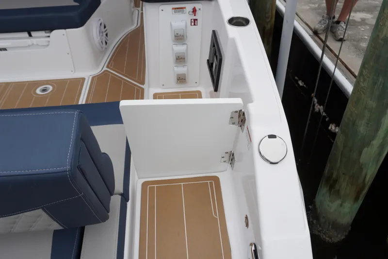 Slide: The Image of 2027 Monterey Elite 34 OB boat interior with blue seating and teak-style flooring. - 14