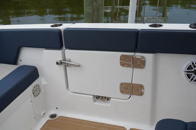 Slide: The Image of 2027 Monterey Elite 34 OB boat interior with blue seating and storage compartment. - 15