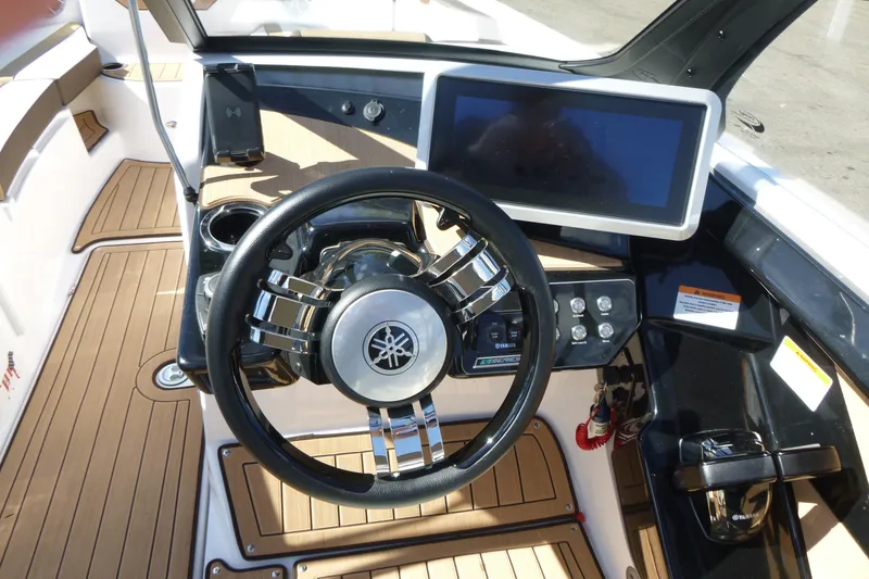 Slide: The Image of 2023 Yamaha Boats 222SD dashboard with steering wheel and touchscreen display. - 10